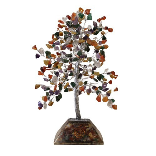A gem tree stands on a trapezoidal stone base. The silver wire branches hold polished, colorful gemstones as leaves in a clear, neutral setting.