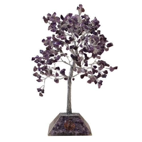 A decorative tree with a silver wire trunk and amethyst "leaves" stands on an amethyst block base against a stark white background. The base features a spiral symbol.