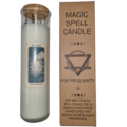 Tall glass jar candle sits next to a cardboard box on a white background; label text: PROSPERITY; TIGERS EYE & GREEN AVENTURINE; MAGIC SPELL CANDLE; LEMON HONEYSUCKLE; SOY WAX; box text: MAGIC SPELL CANDLE; FOR PROSPERITY; SOY WAX CANDLE WITH TIGERS EYE & GREEN AVENTURINE GEMSTONES AND LEMON HONEYSUCKLE FRAGRANCE.
