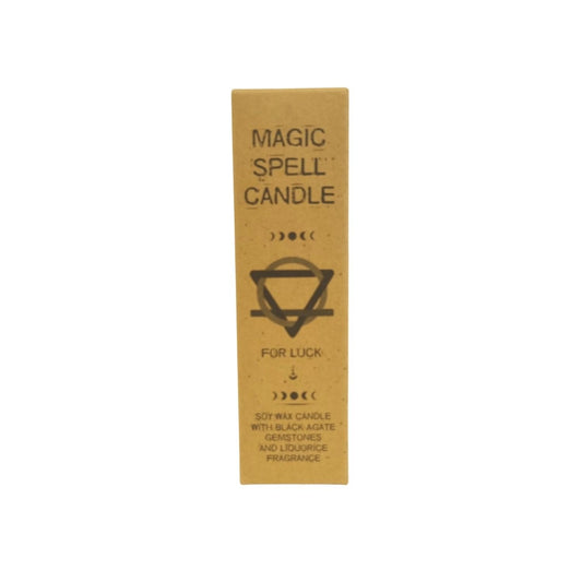 Cardboard candle box stands centered on a white background; text reads: MAGIC SPELL CANDLE FOR LUCK SOY WAX CANDLE WITH BLACK AGATE GEMSTONES AND LIQUORICE FRAGRANCE -