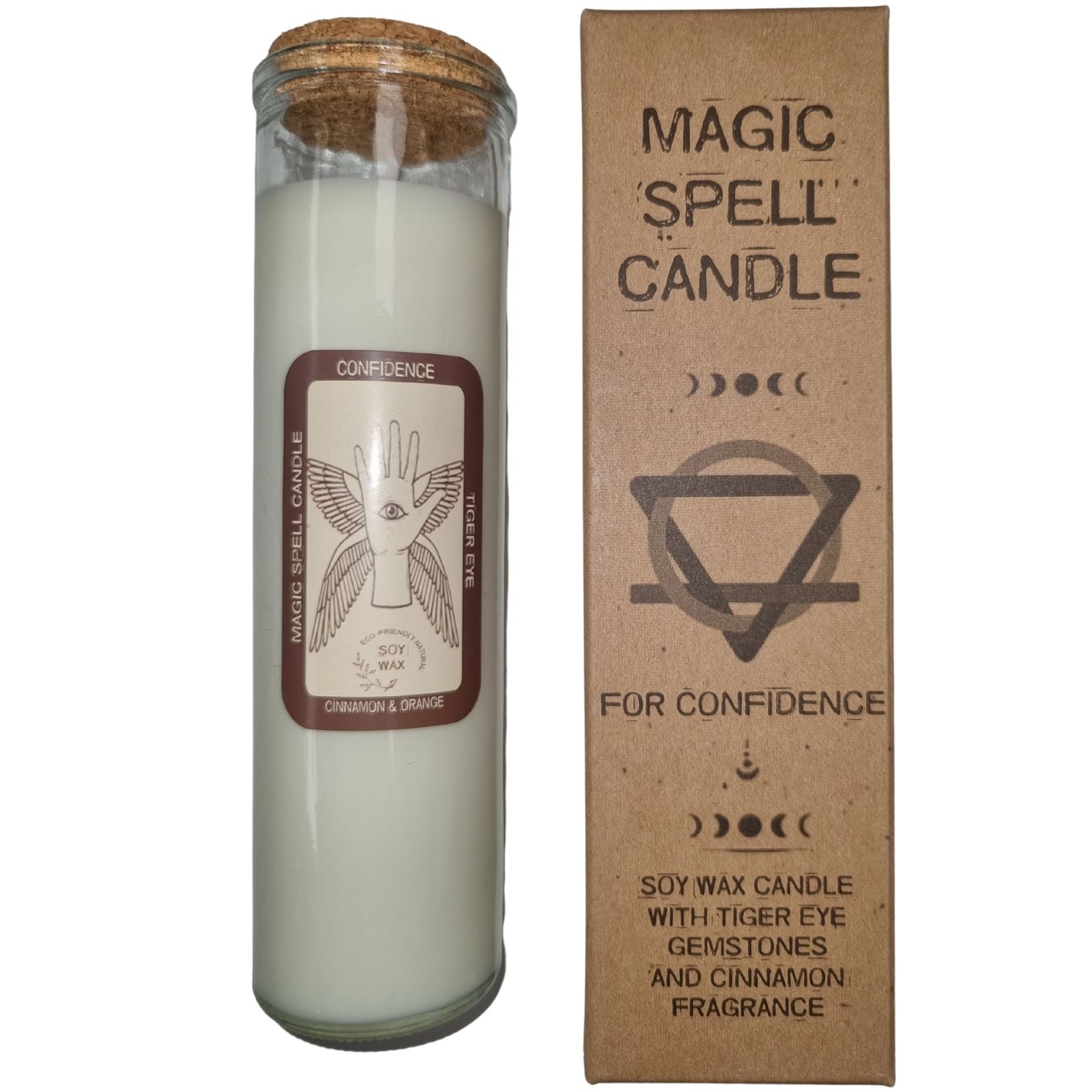 A glass candle with cork stopper stands next to its box labeled "MAGIC SPELL CANDLE," "FOR CONFIDENCE," and "SOY WAX CANDLE WITH TIGER EYE GEMSTONES AND CINNAMON FRAGRANCE." The candle's label states "CONFIDENCE," "TIGER EYE," and "CINNAMON & ORANGE."