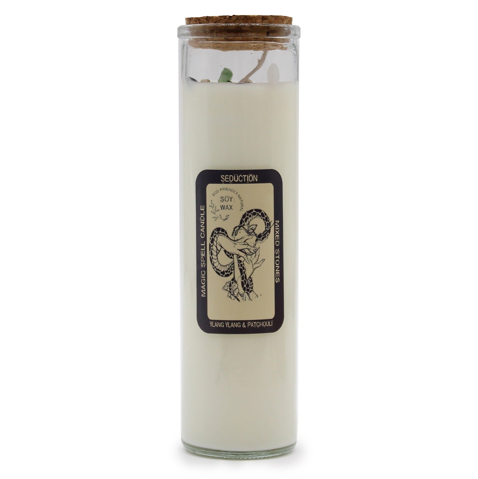 A clear glass jar candle sits on a white surface. The candle is filled with wax and sealed with a cork. The jar has a label that says, “SEDUCTION ECO-FRIENDLY NATURAL SOY WAX MAGIC SPELL CANDLE MIXED STONES YLANG YLANG & PATCHOULI”.