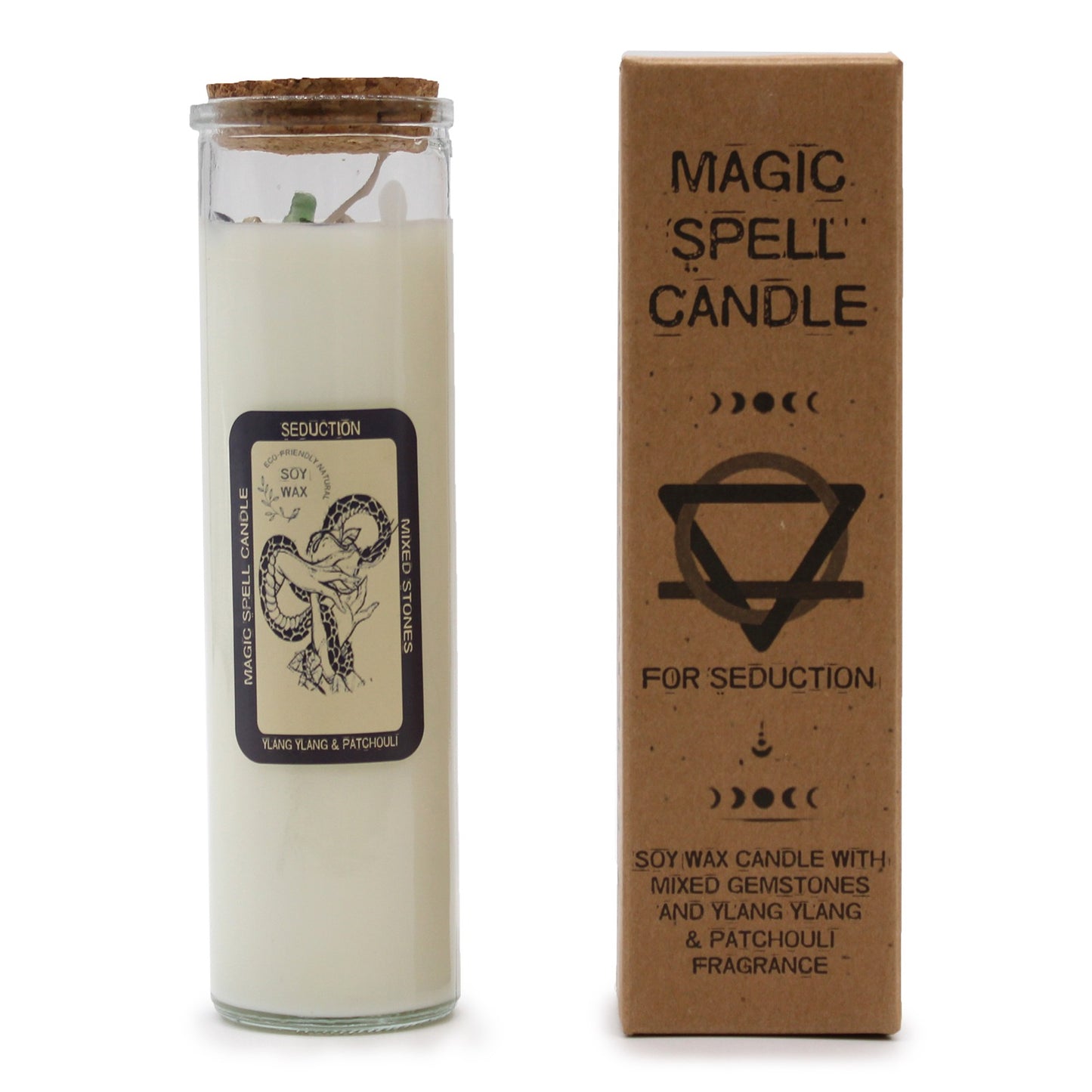 A candle and its box sit on a white surface. The candle is glass-encased and topped with a cork. The label reads: "MAGIC SPELL CANDLE", "SEDUCTION", "SOY WAX", "MIXED STONES", "YLANG YLANG & PATCHOULI". The box reads: "MAGIC SPELL CANDLE", "FOR SEDUCTION", "SOY WAX CANDLE WITH MIXED GEMSTONES AND YLANG YLANG & PATCHOULI FRAGRANCE".