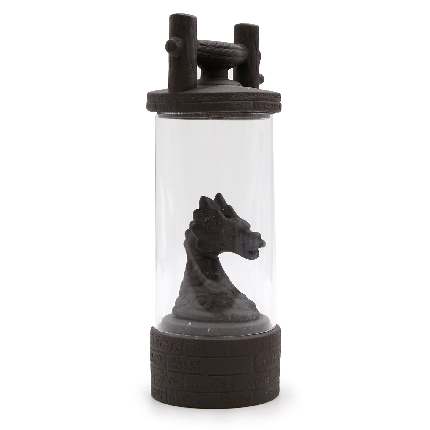 A dragon-head sculpture is enclosed in a cylindrical glass container with decorative handles. The base and lid resemble castle stonework, enhancing the fantasy theme.