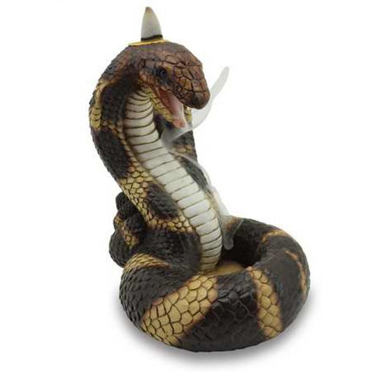 A coiled cobra figurine with raised hood emits smoke from an incense cone on its head, mouth open, against a plain background.