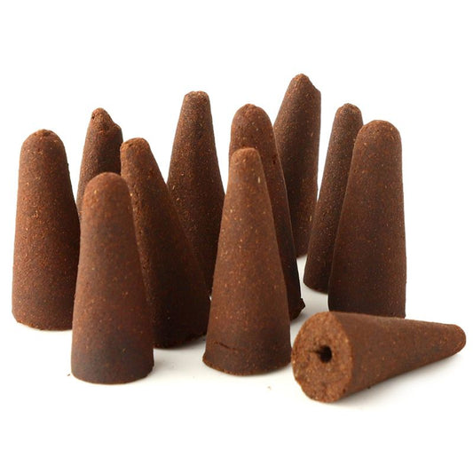 Brown incense cones stand upright, forming a cluster, with one lying horizontally, in a plain white background.