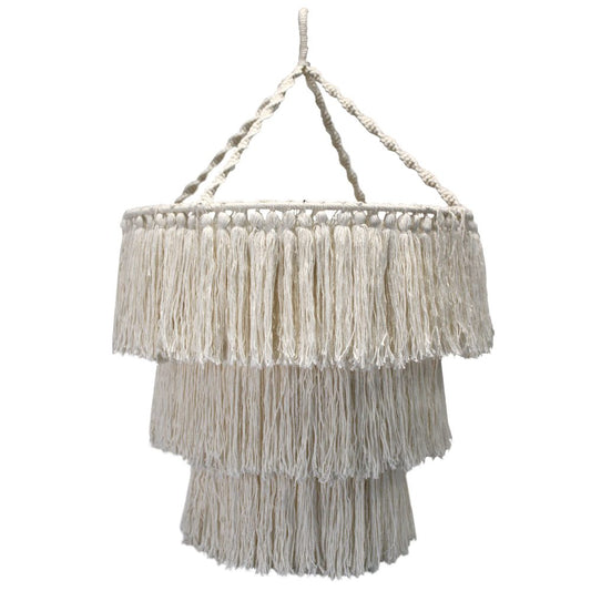 A three-tiered macrame lampshade hangs from a knotted rope frame. The off-white fringe is made of numerous long tassels.
