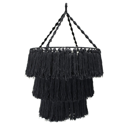 A black, three-tiered tassel lampshade hangs from a twisted cord.