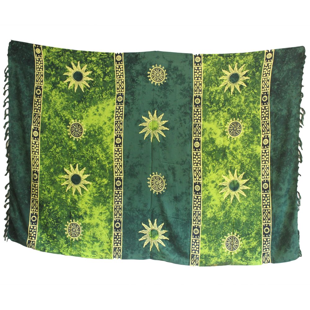 A rectangular sarong hangs, displaying a batik pattern of suns and vertical stripes in shades of green.