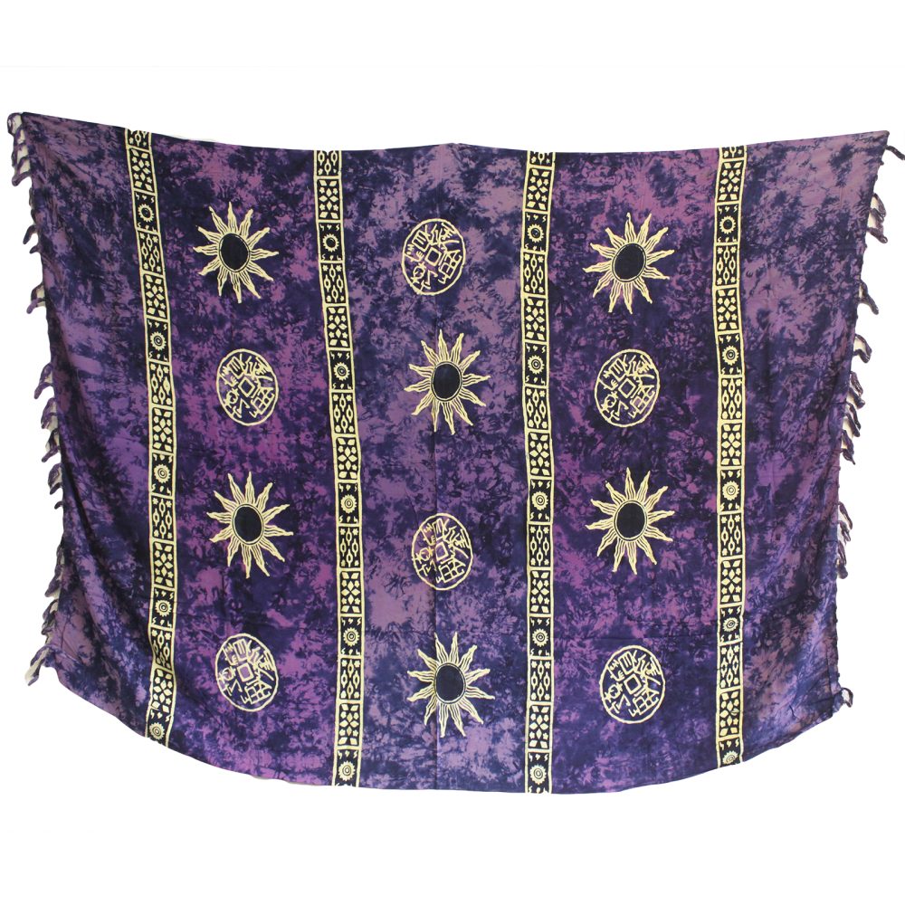 A purple rayon sarong hangs against a white background. It is decorated with repeating patterns of suns and circular symbols in a lighter color.