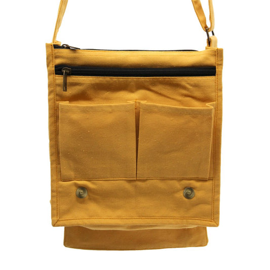 A marigold-colored rectangular canvas bag hangs from a thin strap against a white background. It features two small open pockets, a zipper closure, and two snap closures on the bottom flap.