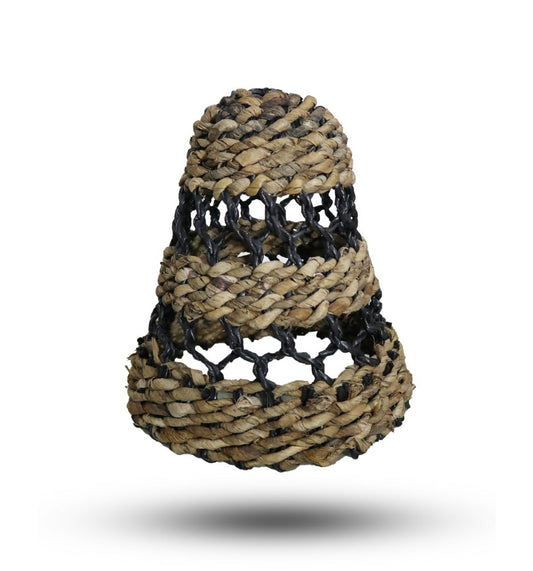 A woven, bell-shaped basket, featuring layers of tan straw and dark netting, hangs against a white background.