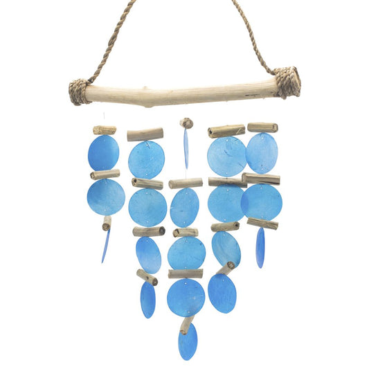 Blue Driftwood Chime handmade with blue Capiz shell and natural driftwood hanging in a garden.