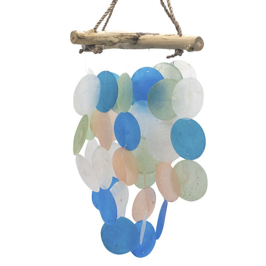 A wind chime hangs from a driftwood bar. Numerous translucent, pastel-colored discs of varying sizes are strung together and gently sway.