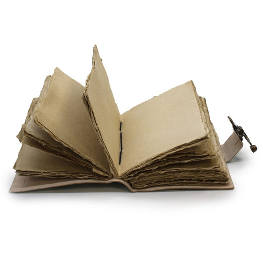 An open, blank journal with rough, brown paper pages lies on a white surface. The pages are hand-stitched with thick thread and secured with a metal clasp.