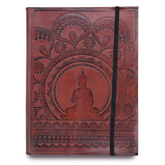 A journal rests, its cover a red-brown leather stamped with a Buddha in meditation, encircled by floral patterns. A black elastic band vertically holds the journal closed, on a stark white backdrop.