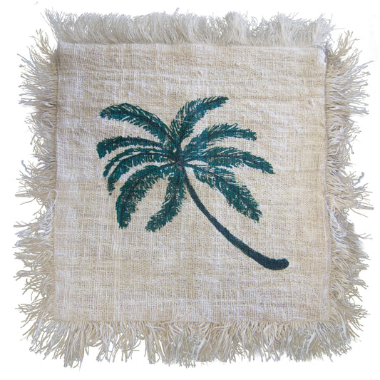A square textile displays a teal palm tree. The fabric has a frayed, off-white border. The background is a light beige woven material.