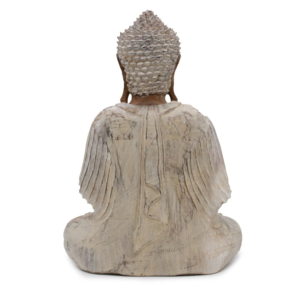A rough-hewn stone Buddha statue sits in meditation, viewed from behind, highlighting its textured head and smooth drapery, isolated against a plain white background.
