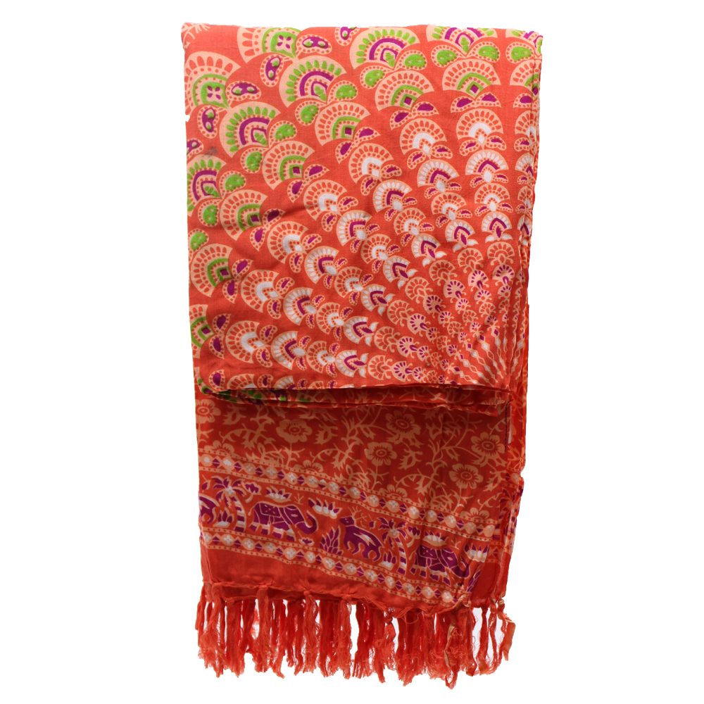 A patterned textile, folded, displays orange and purple mandala and elephant designs; it hangs against a white background.
