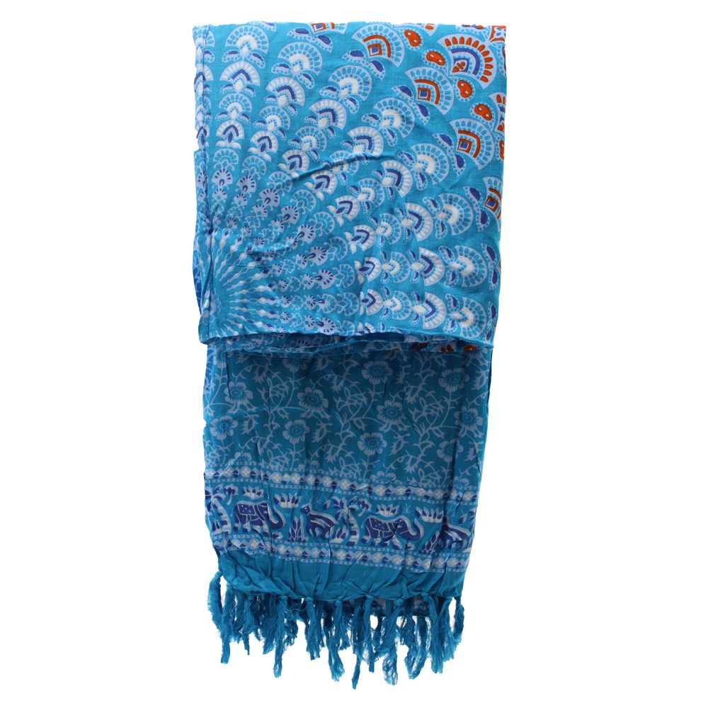A blue patterned sarong, folded, displays mandala and animal prints; it has fringed edges.