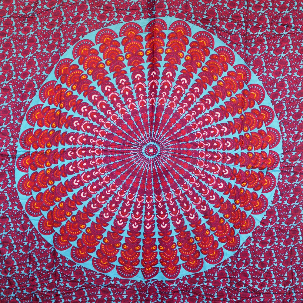 A mandala tapestry displays a colorful, circular pattern on a teal background. The design features radiating, red and orange, floral motifs.