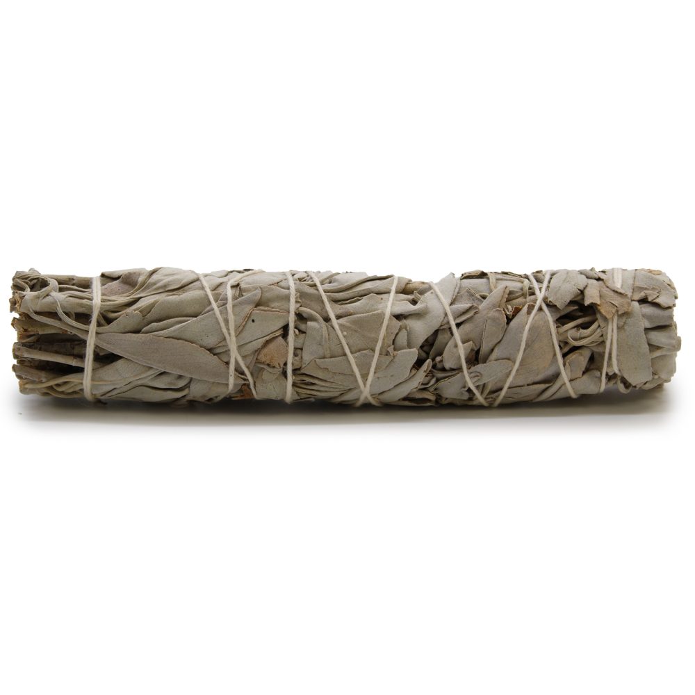 A bundle of dried sage, tightly wrapped with string, lies horizontally against a stark white background.
