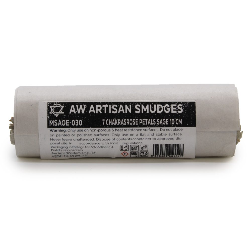 A sage smudge stick bundle sits on a white surface; it's labeled, “AW ARTISAN SMUDGES MSAGE-030 7 CHAKRASROSE PETALS SAGE 10 CM.” Warnings and packaging information are also printed on the label.