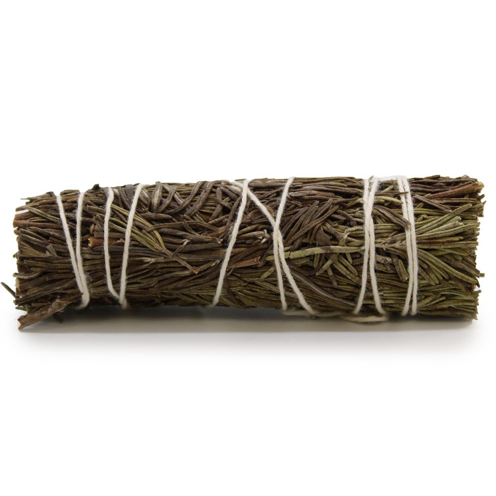 A bundle of dried rosemary is bound with white string and rests on a white surface, casting a shadow.