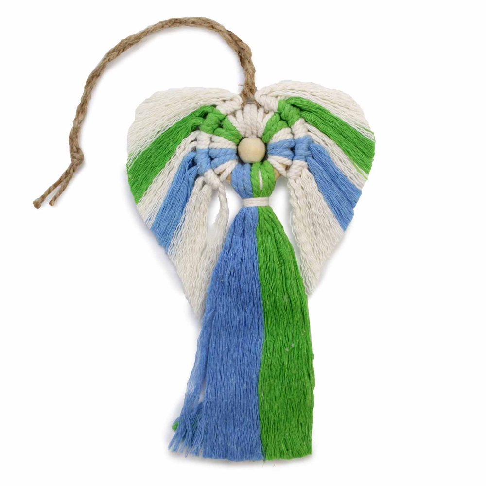 A heart-shaped macrame angel, made from white, blue, and green fibers, hangs from a jute cord. It features a wooden bead for the head and a long tasseled body, isolated on white.
