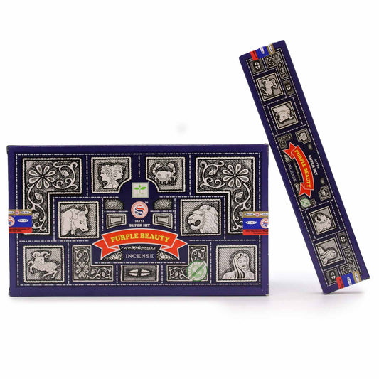 Incense packaging displaying intricate black and white zodiac and floral designs. Main text: "Purple Beauty," "Satya Super Hit," "Incense." The colors are predominantly dark blue with decorative elements.
