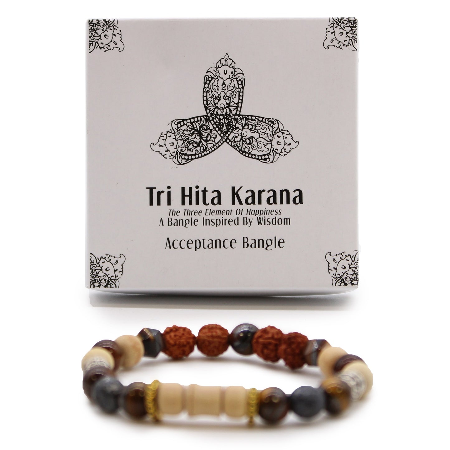 A beaded bracelet rests in front of its packaging, on a white surface. The box features a graphic and the text "Tri Hita Karana, The Three Element Of Happiness, A Bangle Inspired By Wisdom, Acceptance Bangle."