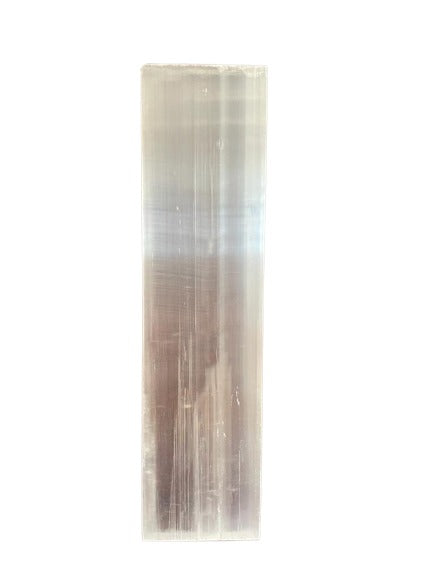 A rectangular prism, ranging in color from light gray to milky brown, stands vertically against a white background.