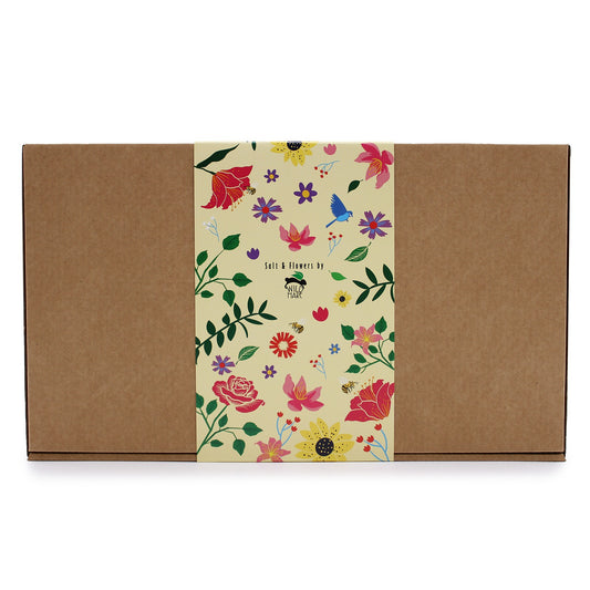 The cardboard box displays a decorative band. The band features flower, leaf, and bird images alongside the text, “Salt & Flowers by WILD HARE".