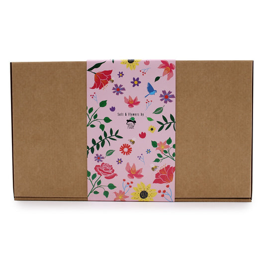 A brown box displays a floral patterned label. "Salt & Flowers by WILD HARE" is printed on the center of the label.