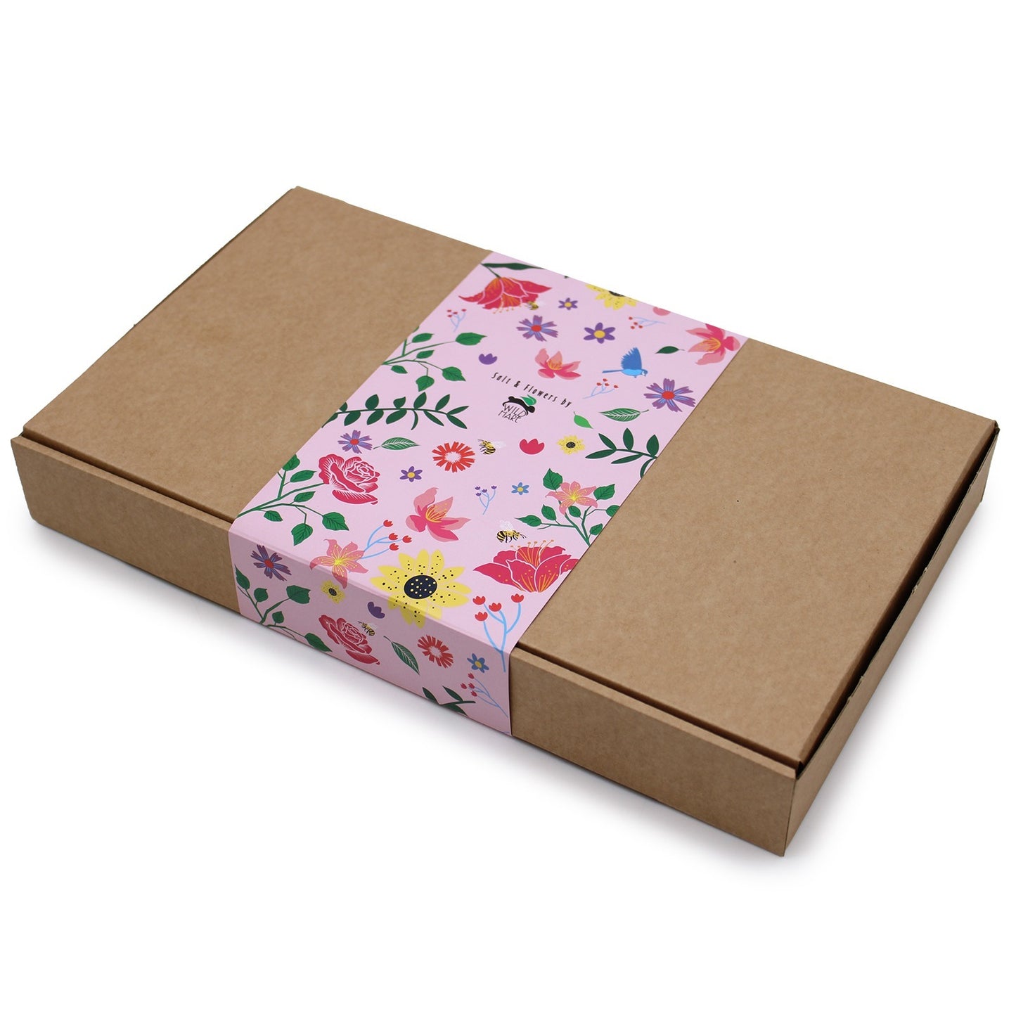 A rectangular, brown cardboard box sits on a white surface. It is decorated with a pink band with a floral pattern and the text "Salt & Flowers by WILD HARE."
