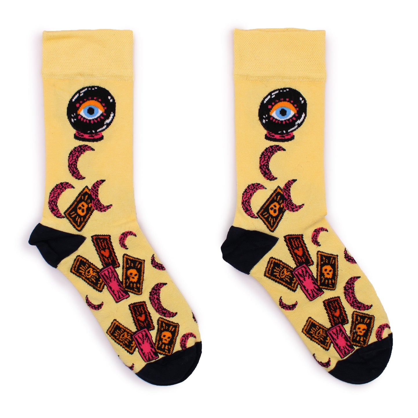 Two socks, displaying a pattern of crystal balls, tarot cards, and crescent moons, rest on a white background.