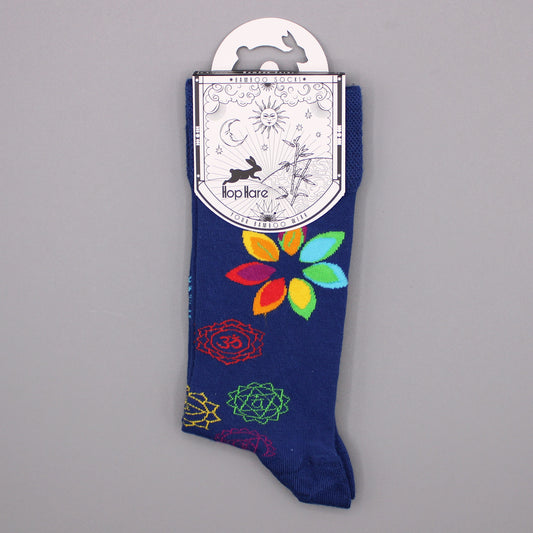 A navy blue sock, featuring colorful floral and mandala designs, hangs on a card. The card reads: *BAMBOO SOCKS*, Hop Hare, YOUR BAMBOO WEAR.