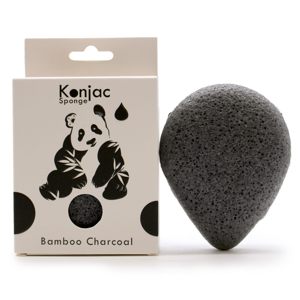 A dark gray konjac sponge sits beside its packaging. The box displays "Konjac Sponge" and "Bamboo Charcoal," along with a panda bear illustration.