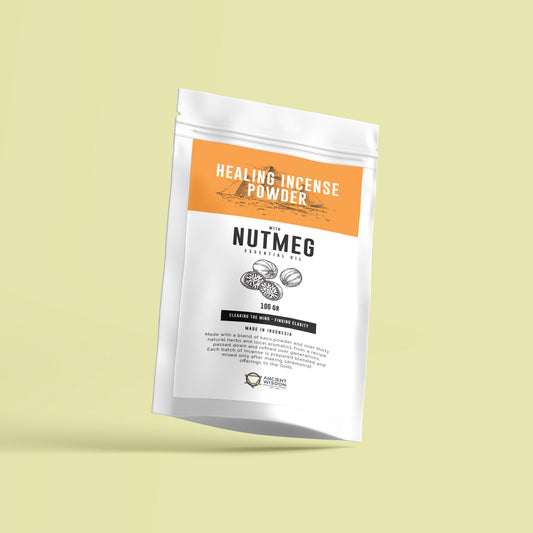 A white package labeled "HEALING INCENSE POWDER" with nutmeg essential oil is prominently displayed. It contains 100 grams and claims to clear the mind and provide clarity. The packaging describes being made with a blend of natural herbs and ingredients from Indonesia. The backdrop is a light, pastel-colored surface.