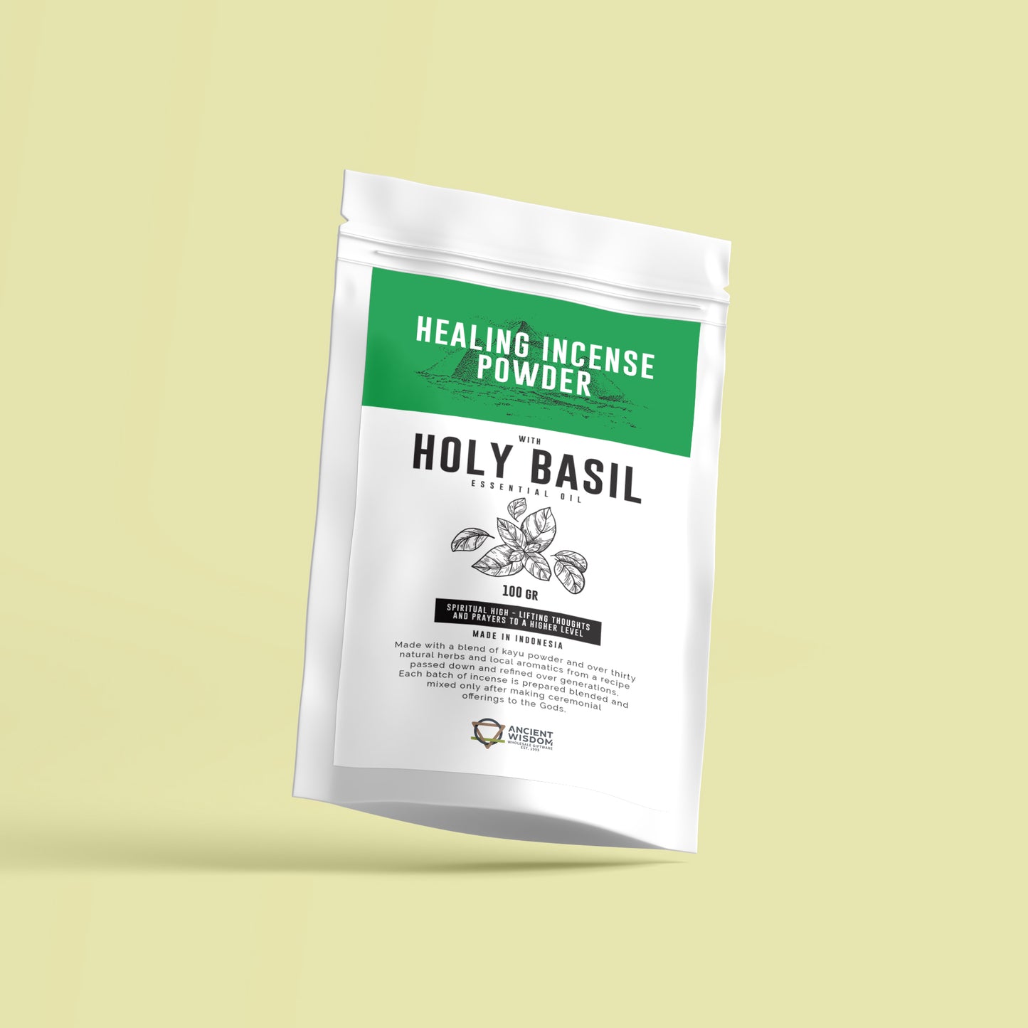 A white package labeled "Healing Incense Powder with Holy Basil Essential Oil" is set against a pale yellow background. Text includes "100 GR," "Made in Indonesia," and details about its spiritual benefits and ingredients.
