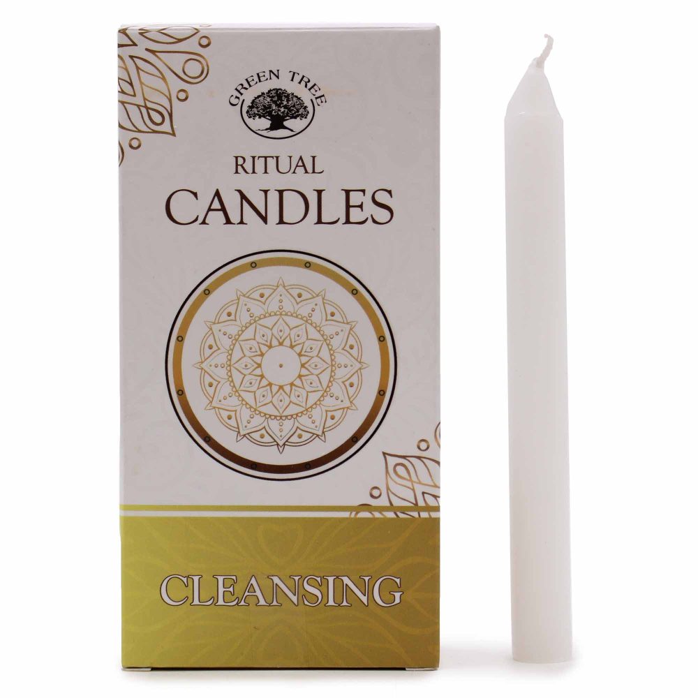 A box of candles sits beside a single white candle. The box reads "GREEN TREE RITUAL CANDLES CLEANSING" and is decorated with gold patterns.