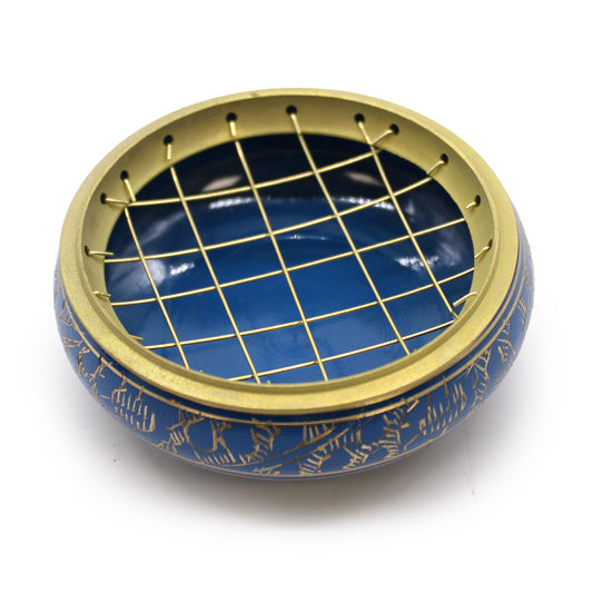 A round, blue ceramic bowl features gold etched patterns on its exterior. Topped with a golden metal grid, it rests on a plain white background, suggesting a decorative purpose.