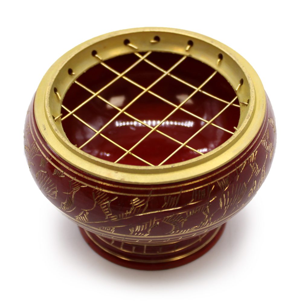 A round, decorative brass-topped incense burner with a lattice pattern on top; it features intricate golden engravings on its maroon body, set against a white background.