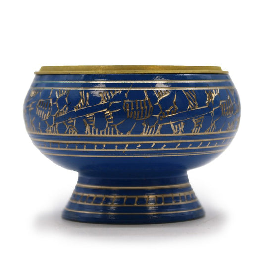 A decorative blue ceramic bowl with golden intricate patterns around its exterior rests on a short pedestal base, set against a plain white background.