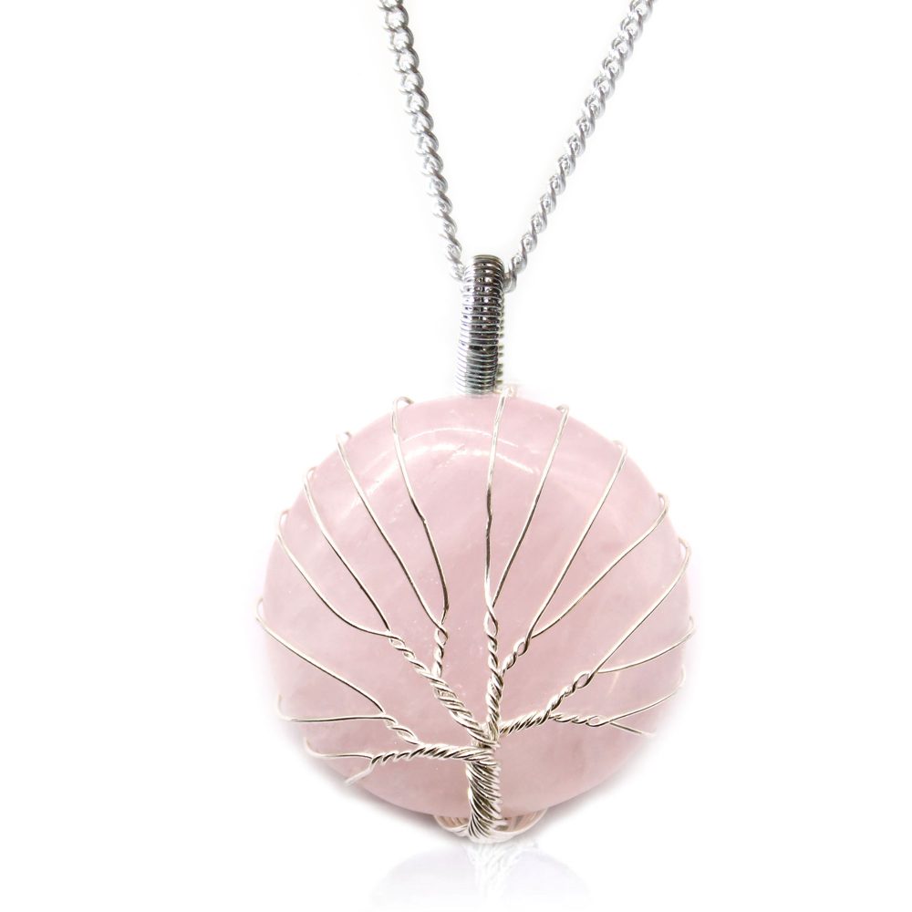A rose quartz sphere, with silver wire wrapped around it in a tree design, hangs from a silver chain against a white background.
