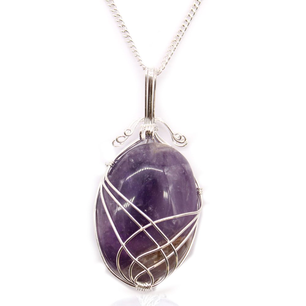 A purple, oval-shaped gemstone is secured within silver wire wrapping and hangs from a silver chain against a white background.