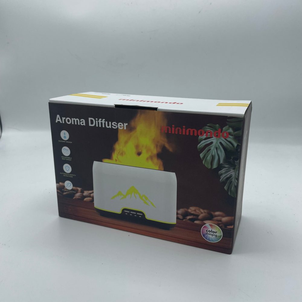 A box, printed with “Aroma Diffuser” and “minimondo,” depicts an aroma diffuser against a backdrop of green plants, coffee beans, and a yellow, flame-like shape. It is set against a plain white background. The box also features the text “ELEGANT DESIGN”, “ADJUSTABLE MIST SPRAY”, “AUTOMATIC SAFETY DETECTION”, “VARIABLE CONTROL”, and “color changing.”