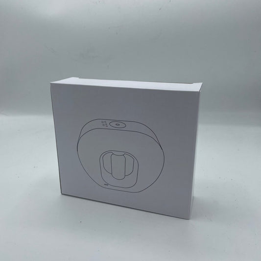 A white product box sits on a white surface, with a line drawing of a round device printed on the box's face.