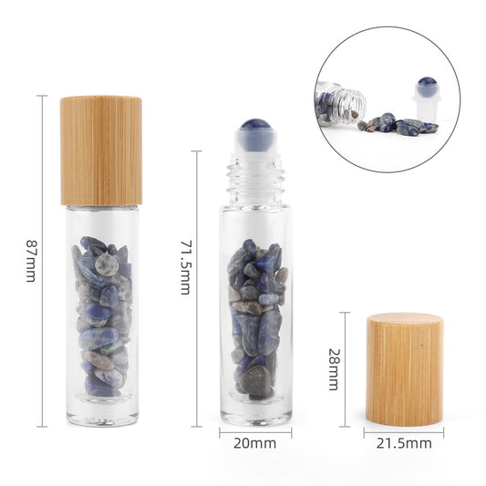 The image shows a set of small, transparent glass bottles filled with blue stones with various measurements written in black: 87mm, 71.5mm, 20mm, 28mm, 21.5mm. Some have light wooden caps, while others have roller ball tops.