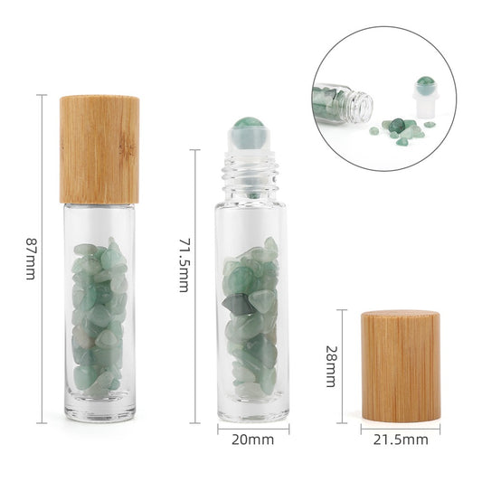 Glass roller bottles stand next to caps with the surrounding measurements of 87mm, 71.5mm, 28mm, 20mm, and 21.5mm; both bottles filled with green stones. A small image in a circle shows the bottle and stone contents.